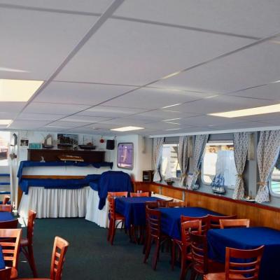 Tables and chairs on the inside of the boat