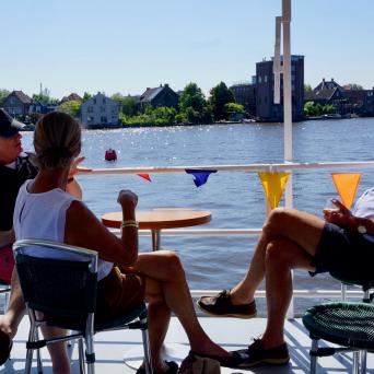 Three people sitting at a table on the boat
