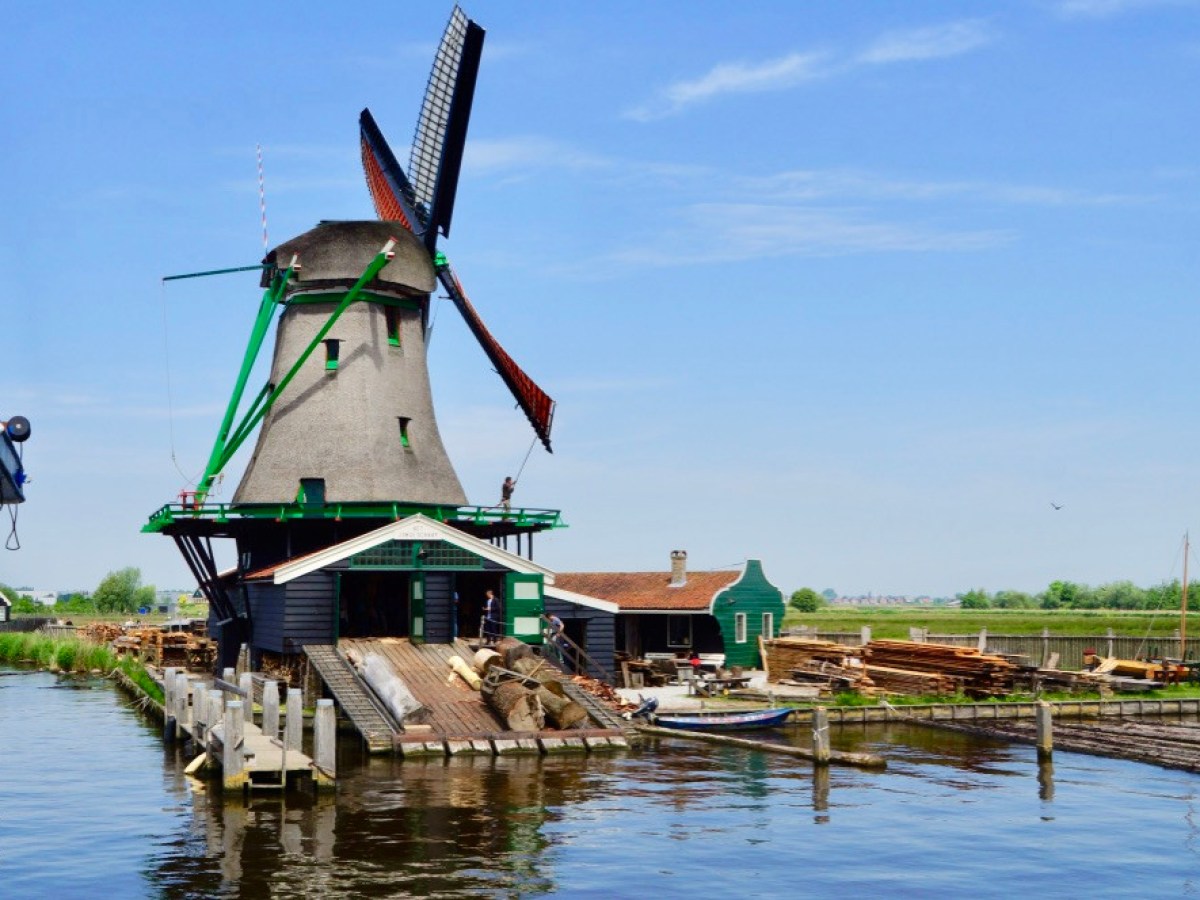 View from the boat onto a big windmill