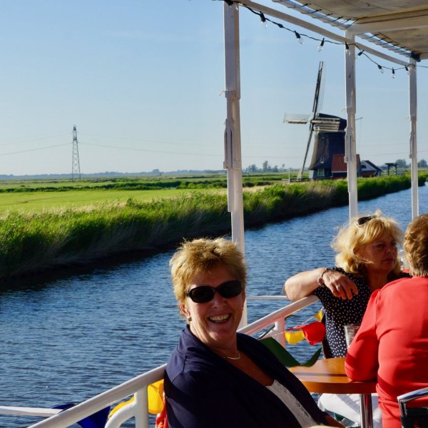 a group of people standing in front of a body of water