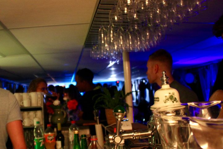 a group of people sitting at a table with wine glasses